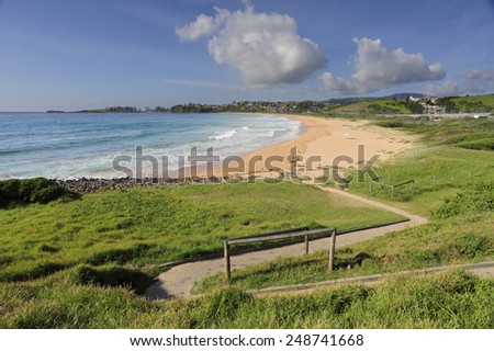 The zig-zag path leads down to Bombo Beach on the south coast of NSW Australia on a beautiful summer morning, with empty lifeguard chair