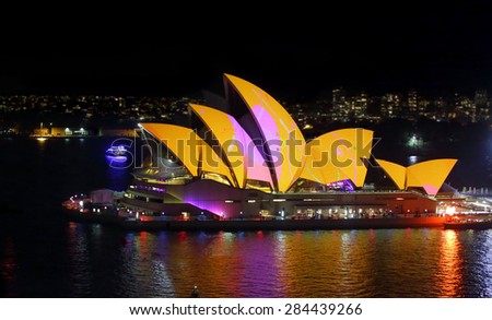 SYDNEY, AUSTRALIA - MAY 27, 2015; The Sydney Opera House comes alive each night during Vivid Sydney.   Here the roof alight in vivid yellow, orange and pink. 8000 iso