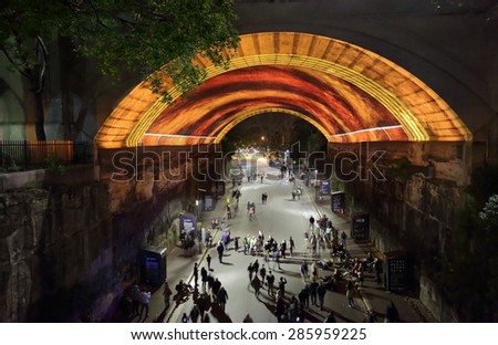 SYDNEY, AUSTRALIA - MAY 23, 2015;  View down into Argyle Street The Rocks as public watch, photograph or video  Life Story  for Vivid Sydney. People in motion
