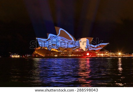 SYDNEY, AUSTRALIA, MAY 22, 2015;  Hand grabbing blue squiggles projection image during Vivid Sydney