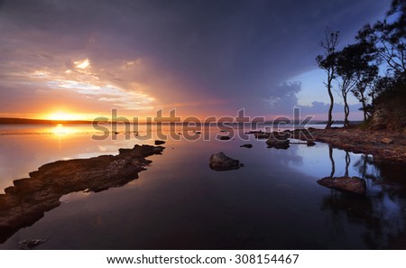 Stormy sunset over the serene waters of St Georges Basin, Sanctuary Point, Australia