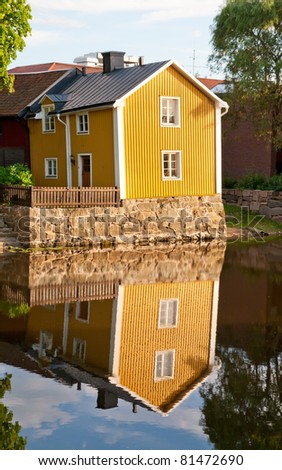 A reflection of a yellow house near Arboga river, Sweden