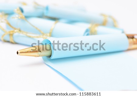 a pen and paper roll isolated on white