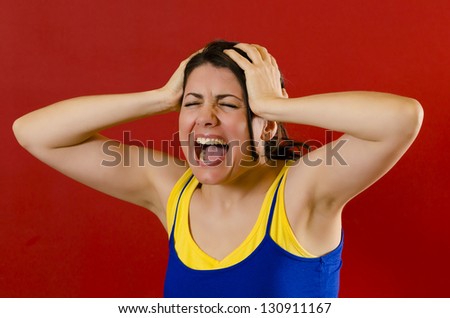 Angry woman screaming loud , isolated on red