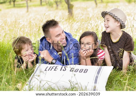 Father spending time with three kids in nature