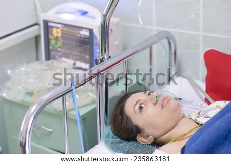 Woman being monitored in a recovery room