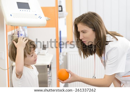 Angry kid refusing an orange at doctor visit