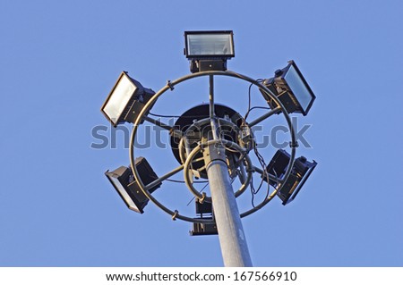 six spotlight lamps on the pole under the blue sky