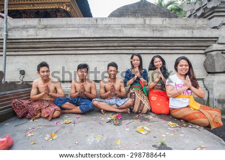 BALI, INDONESIA - NOVEMBER 3RD 2014 : Balinese people pose for the camera at the Holy Spring Tirtha Empul Bali, Indonesia.