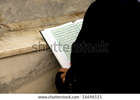 muslim-woman reading the koran on a holiday the Ramadan.