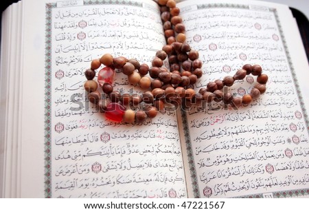 A page from the Koran and beads.