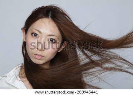 Asian woman fluttering hair