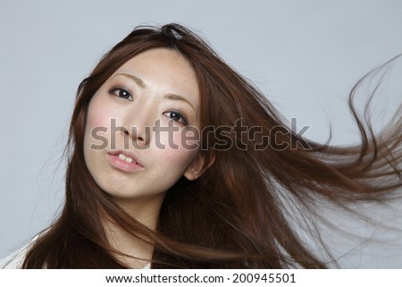 Asian woman fluttering hair