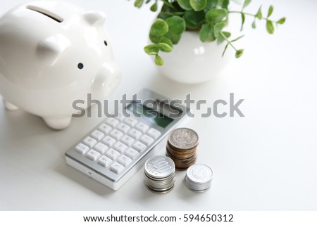 A money box and electronic calculator
