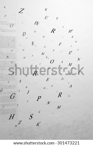 Random letters cloud on a wall added with an acrylic text