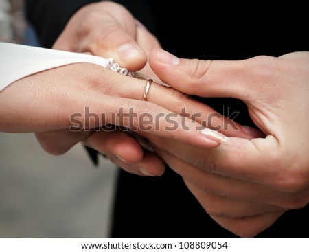 man wears a gold ring to his future wife