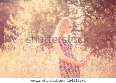 Beauty Romantic Girl Outdoors. Beautiful Teenage Model Girl Dressed In Casual Short Dress On The Field In Sun Light. Blowing Long Hair. Autumn. Glow Sun, Sunshine. Backlit. Toned In Warm Colors