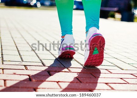 Runner Feet Running on road Closeup in shoe. woman fitness workout  concept
