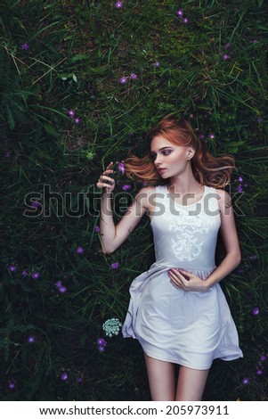 fabulous portrait woman lying down in field with flowers