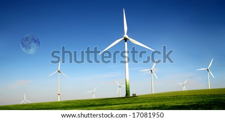 Wind turbines farm with full moon. Alternative energy source.