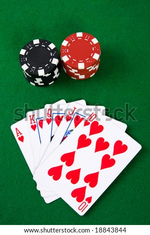 Poker arrangement with poker chips on green poker table.