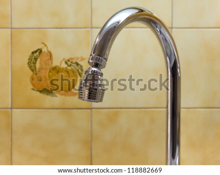 Kitchen Faucet Against a Tiled Wall