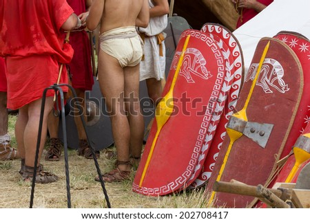 A Set of Legionary Shields and a Group of Soldiers in an Ancient Roman Encampment