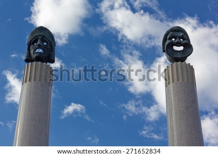 Bronze Sculptures of Ancient Greek Theater Masks on the Top of Two Marble Columns