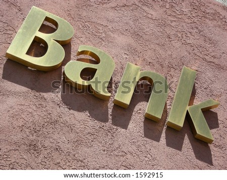 Gold bank sign slanted, on a roll