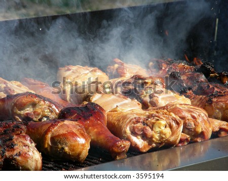Turkey drumsticks cooking on an open fire