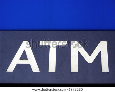 Automated teller machine sign in front of a bank