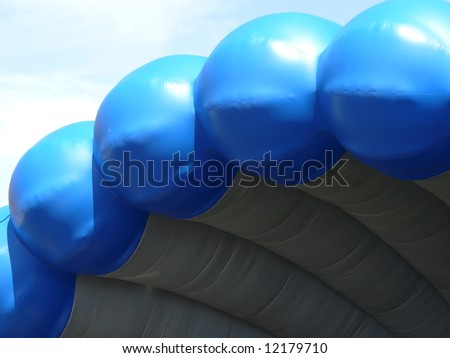 Roof over inflatable outdoor stage against a mostly clear sky