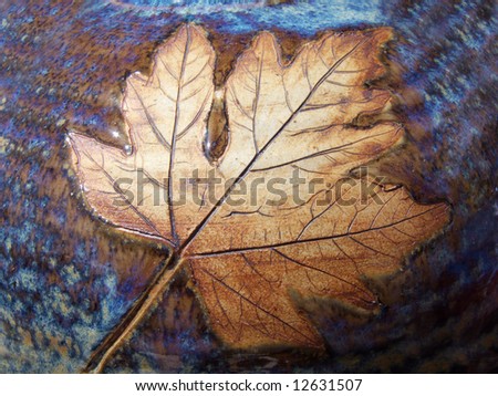 Brown Maple leaf captured in ceramic swirl