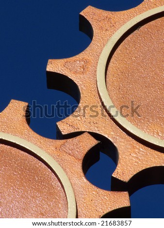Interlocking gears against a blue sky backdrop