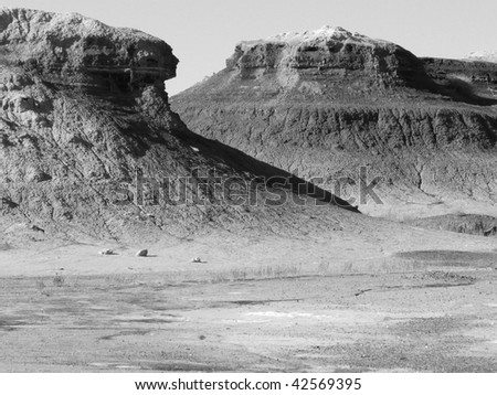 Rock formations in the Badlands of the Southwest desert - black and white photograph