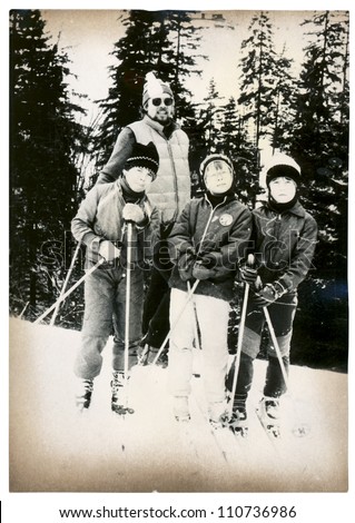 Eastern Bohemia, Giant, CZECHOSLOVAK REPUBLIC, CIRCA 1980 - man and three kids (boy) skiing - circa 1980