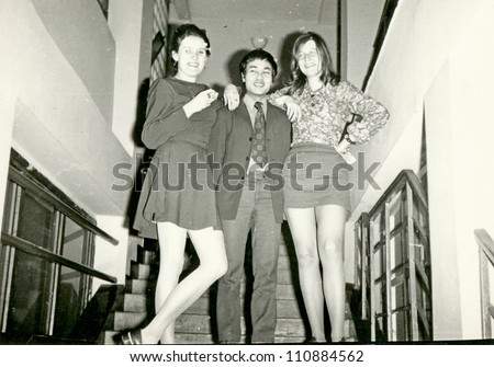 ZVOLEN, CZECHOSLOVAK REPUBLIC, CIRCA 1970 - college students on the stairs (two young women, European women and a man, Vietnamese) - circa 1970