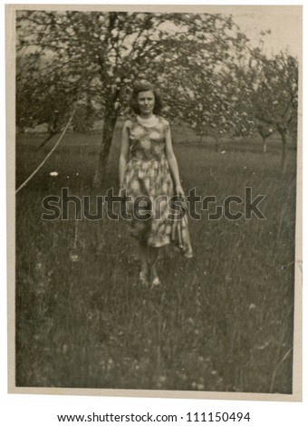 CENTRAL BULGARIA, BULGARIA,- CIRCA 1950: the area Plovdiv - young woman in an orchard of fruit trees - circa 1950