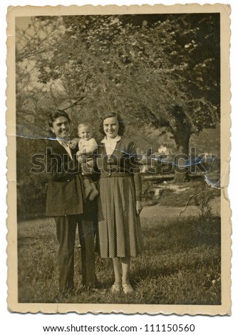 CENTRAL BULGARIA, BULGARIA,- CIRCA 1950: the area Plovdiv - young couple with their child between fruit trees - circa 1950