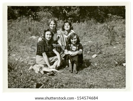 CENTRAL BULGARIA, BULGARIA,- CIRCA 1965: Four young women, friends, sitting in nature. Note: slight blurriness, better at smaller sizes - circa 1965