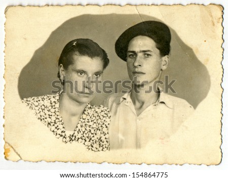 CENTRAL BULGARIA, BULGARIA - CIRCA 1950: Common photo of a young man and young woman (couple - husband and wife) - Note: slight blurriness, better at smaller sizes - circa 1950