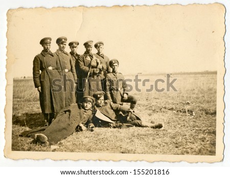 CENTRAL BULGARIA, BULGARIA - CIRCA 1945: Group of soldiers in long coats posing in the field - Note: slight blurriness, better at smaller sizes - circa 1945