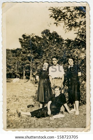 CENTRAL BULGARIA, BULGARIA - CIRCA 1955: the area Plovdiv - Three women and one man posing in nature - Note: slight blurriness, better at smaller sizes - circa 1955