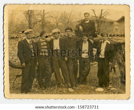 CENTRAL BULGARIA, BULGARIA - CIRCA 1940: the area Plovdiv - Group of men and boys on private land overgrown with bushes - Note: slight blurriness, better at smaller sizes - circa 1940