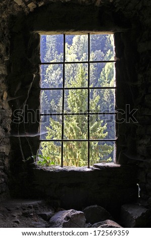 Old Castle window in darkness with spiderwebs