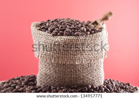 Coffee sack - coffee beans in canvas coffee bag studio shot on red background