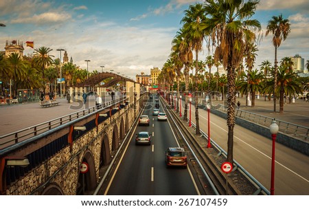 Cars and people on late afternoon streets and pedestrian ways in Seaside Barcelona, Spain