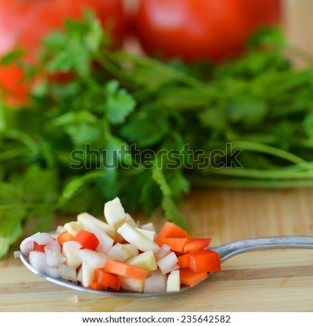 Fresh growing flat leaf parsley background, vegetlables and tomatoes