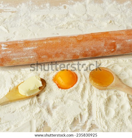 Ingredients and tools for baking on the wooden table close-up