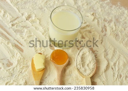 Ingredients and tools for baking on the wooden table close-up